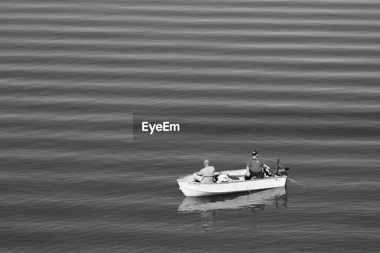 High angle view of people sailing boat in lake