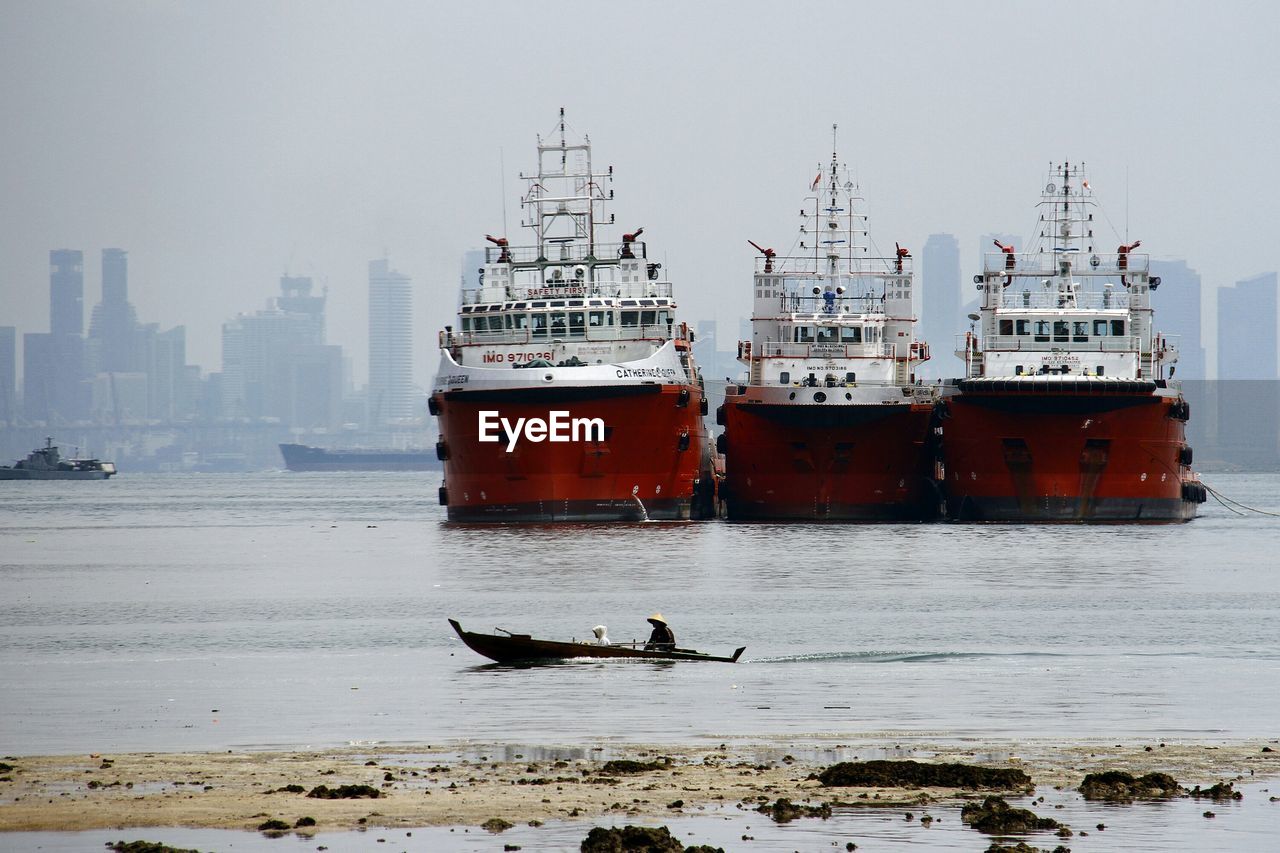 BOATS MOORED IN HARBOR