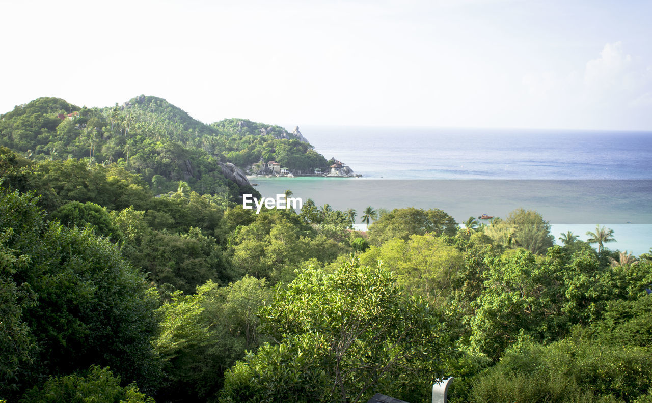 SCENIC VIEW OF SEA WITH MOUNTAIN IN BACKGROUND