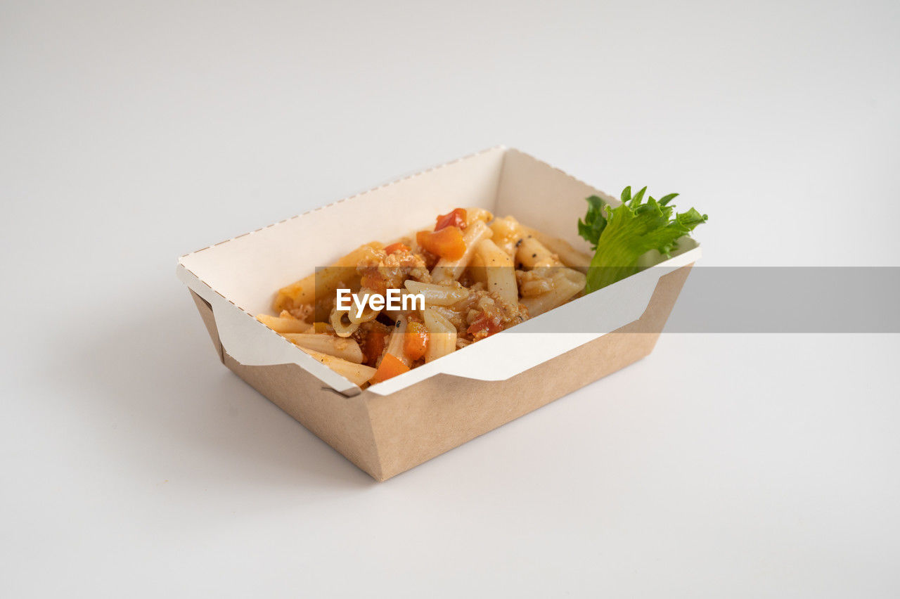 food, food and drink, studio shot, box, no people, dish, indoors, unhealthy eating, vegetable, container, fast food, white background, freshness, fried, take out food, snack, copy space, cuisine, meal, raw potato, paper, high angle view, produce