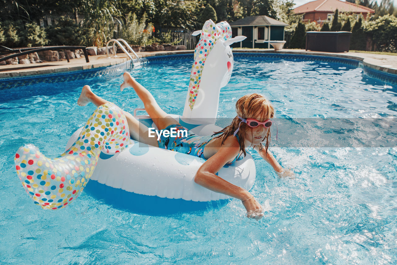 High angle view of girl swimming in pool