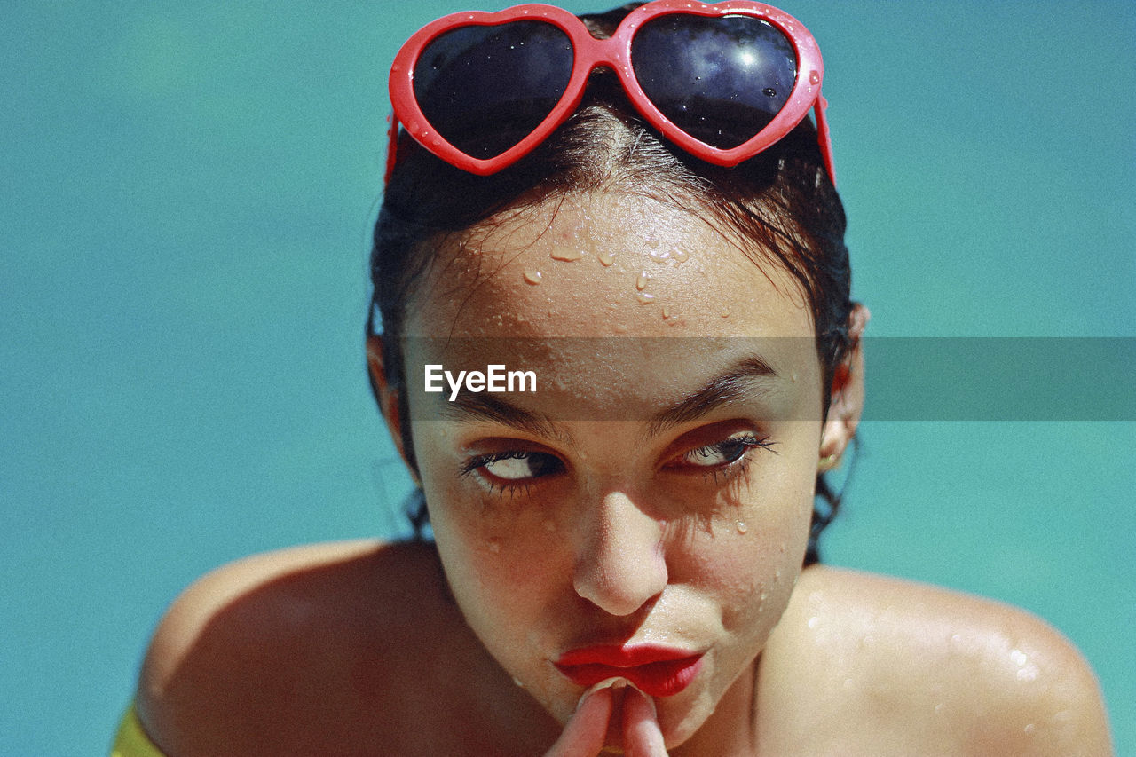 Close-up of thoughtful teenage girl in swimming pool