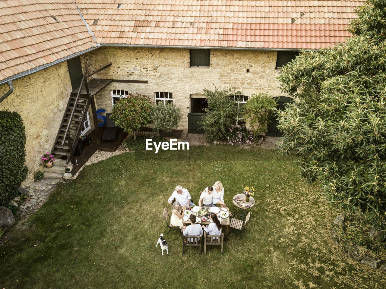 Family eating together in the garden in summer