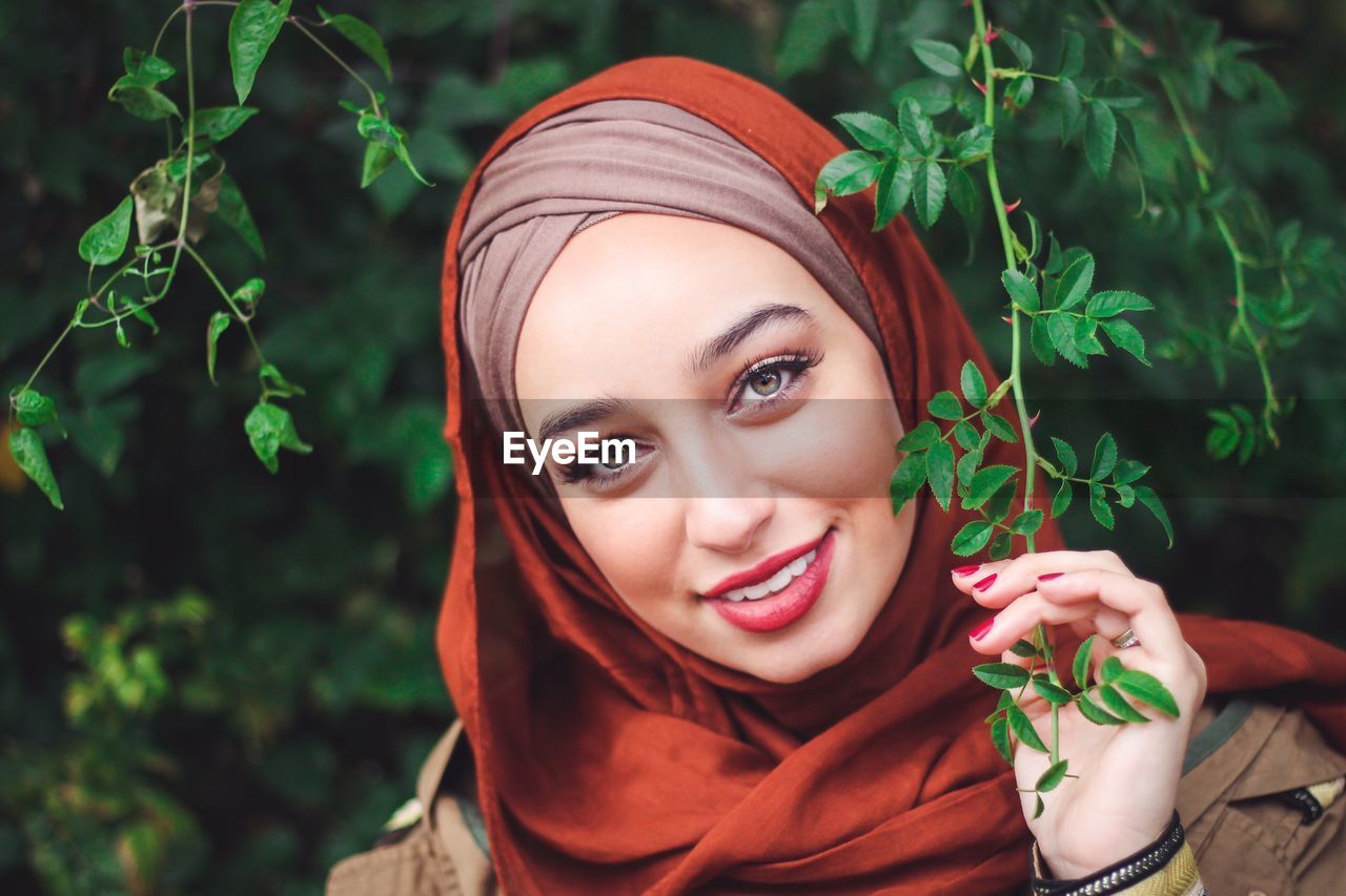 Portrait of smiling young woman wearing hijab