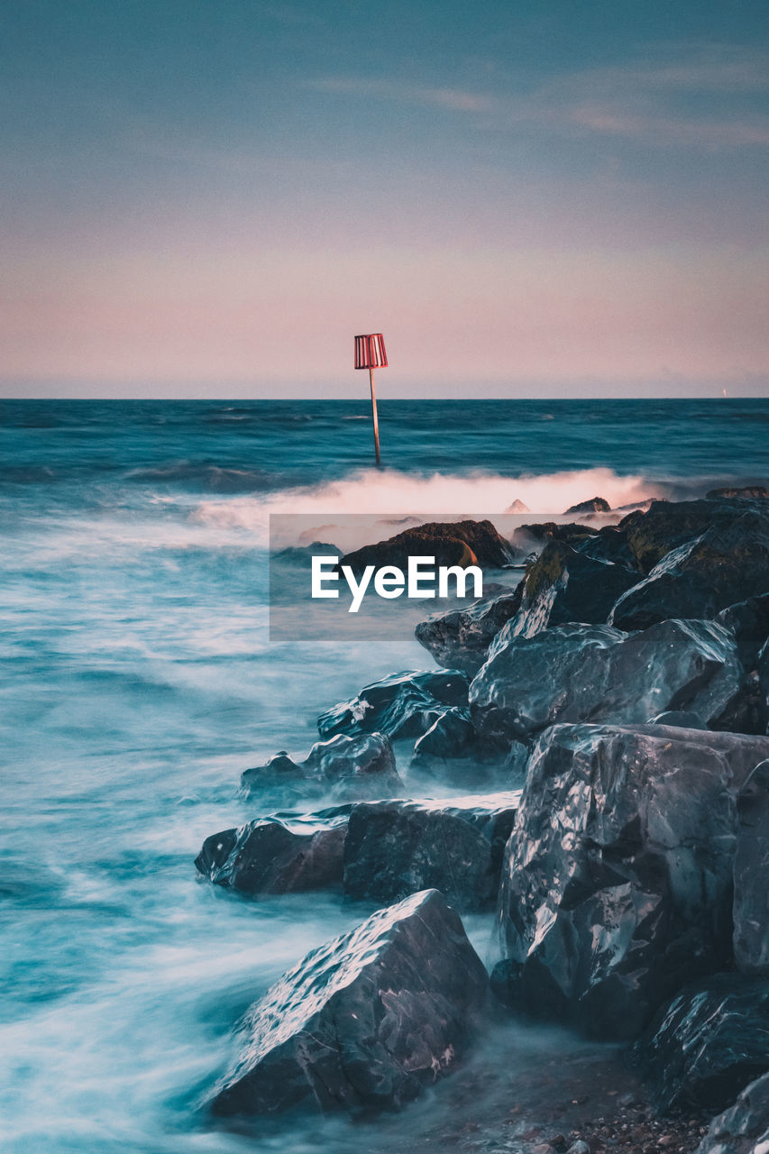 Scenic view of sea against sky moving sea over rocks 