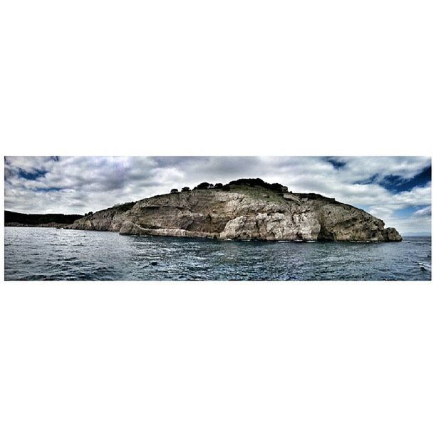 SCENIC VIEW OF SEA WITH ROCKS IN BACKGROUND