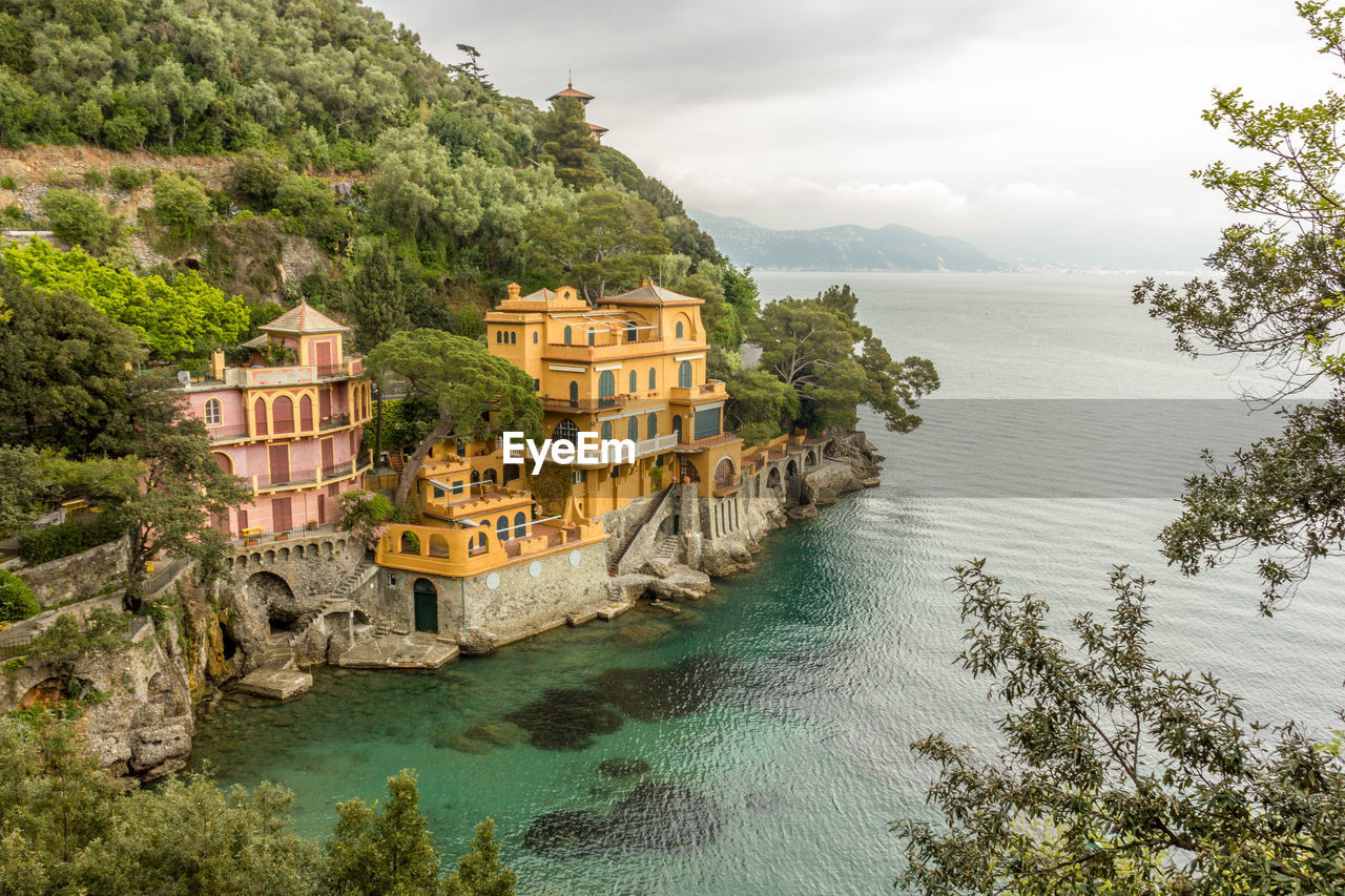 Scenic view of sea against buildings