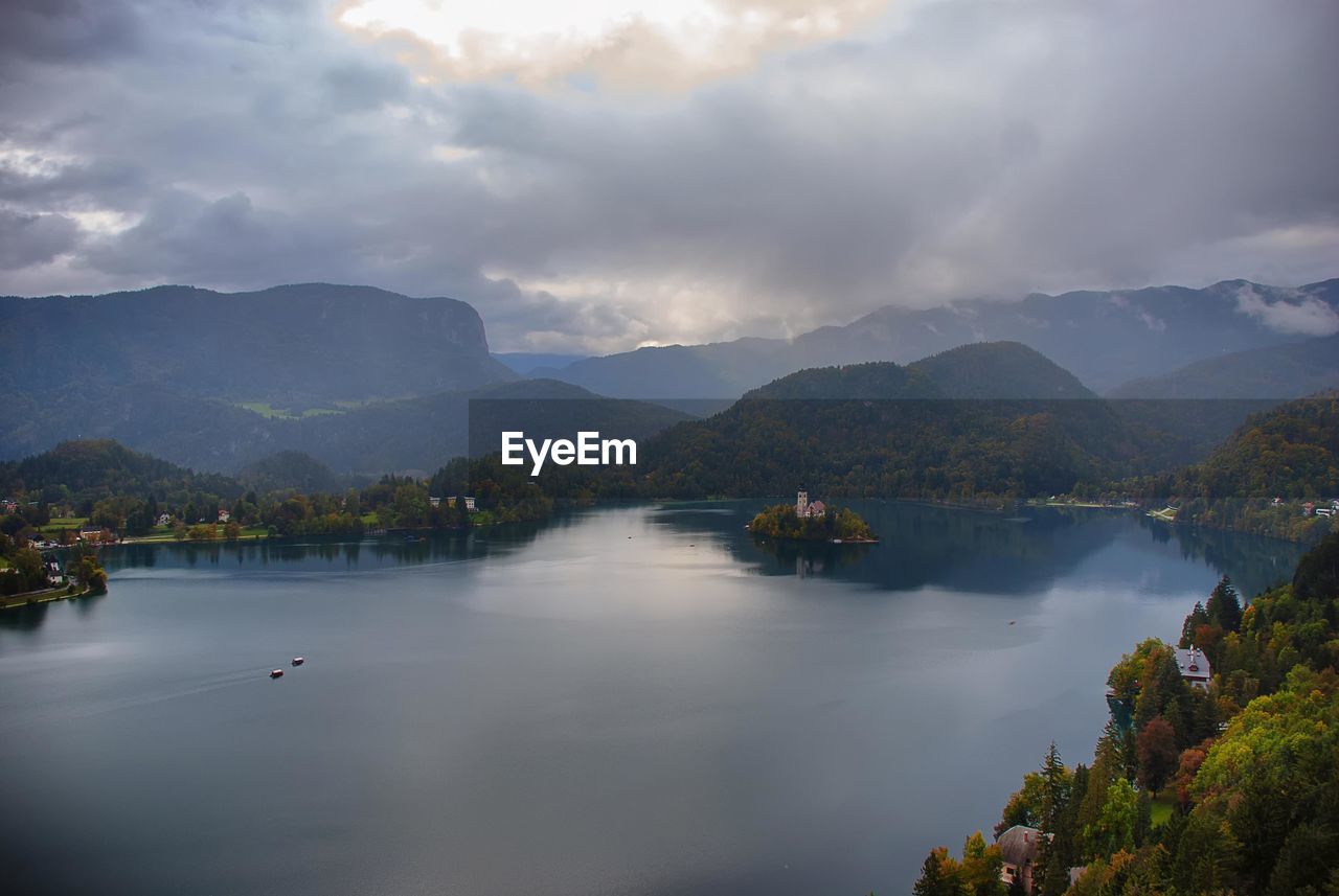 Scenic view of lake and mountains against sky