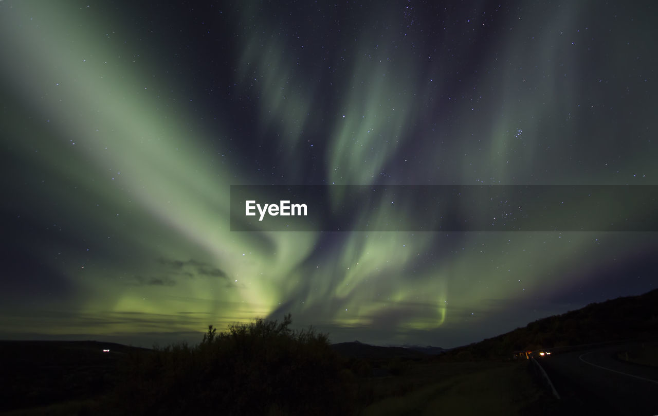 Scenic view of landscape against sky at night