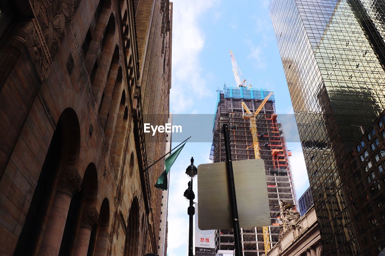 Low angle view of buildings in new york city against sky