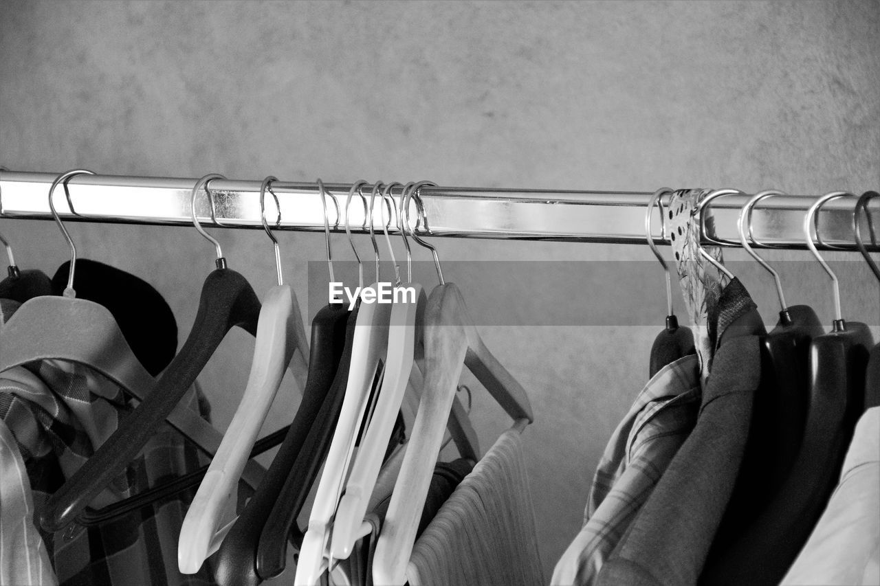 Close-up of clothes hanging on rack at store