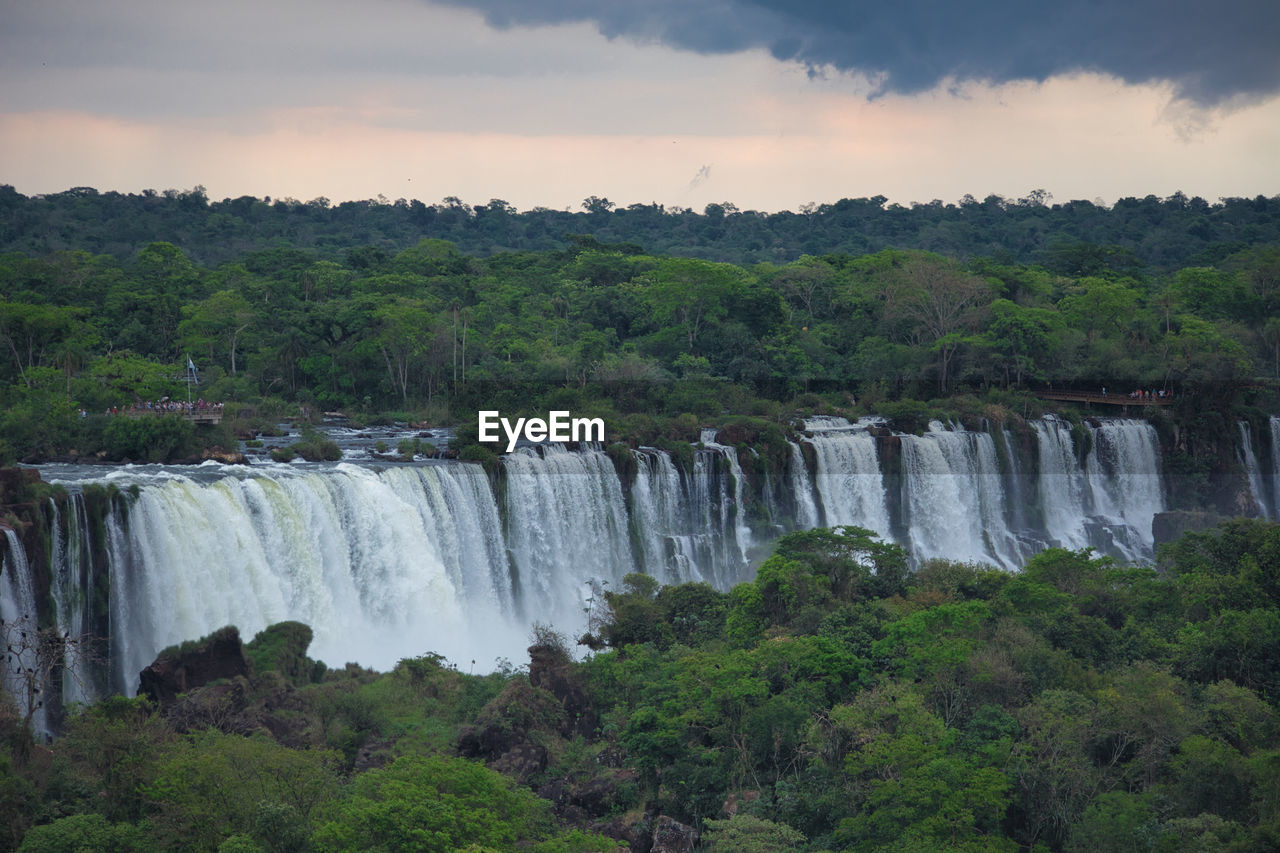 Scenic view of waterfall against sky