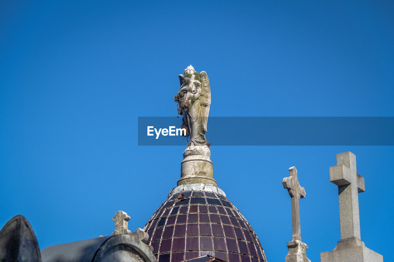 low angle view of liberty against clear blue sky