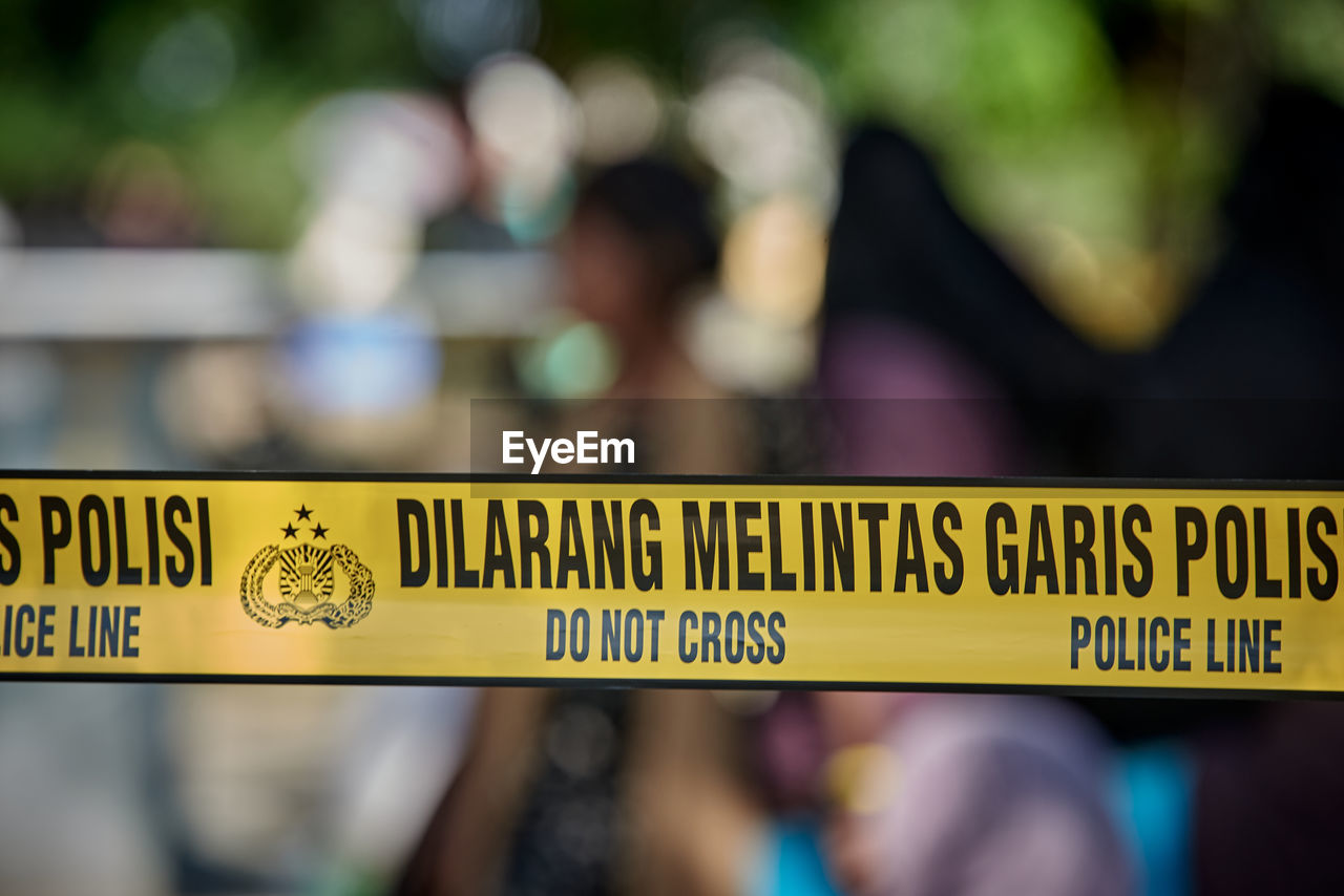 communication, sign, social issues, crime, cordon tape, law, text, crime scene, focus on foreground, person, group of people, security, warning sign, day