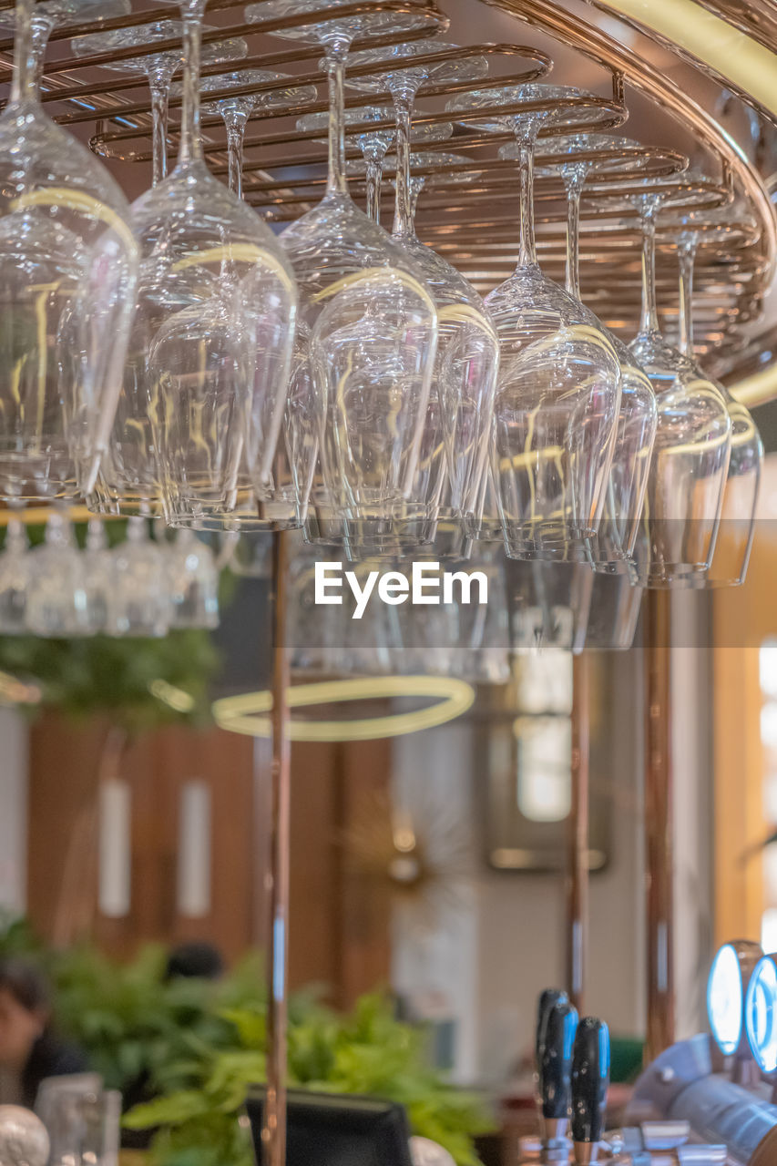 CLOSE-UP OF WINE GLASS HANGING FROM CEILING