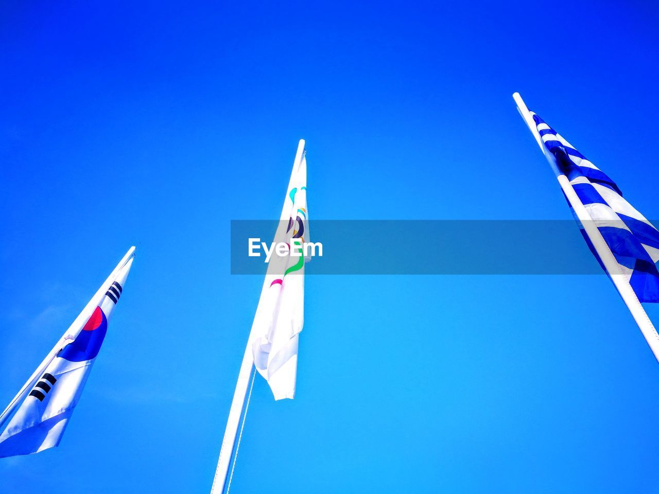 LOW ANGLE VIEW OF FLAG AGAINST BLUE SKY
