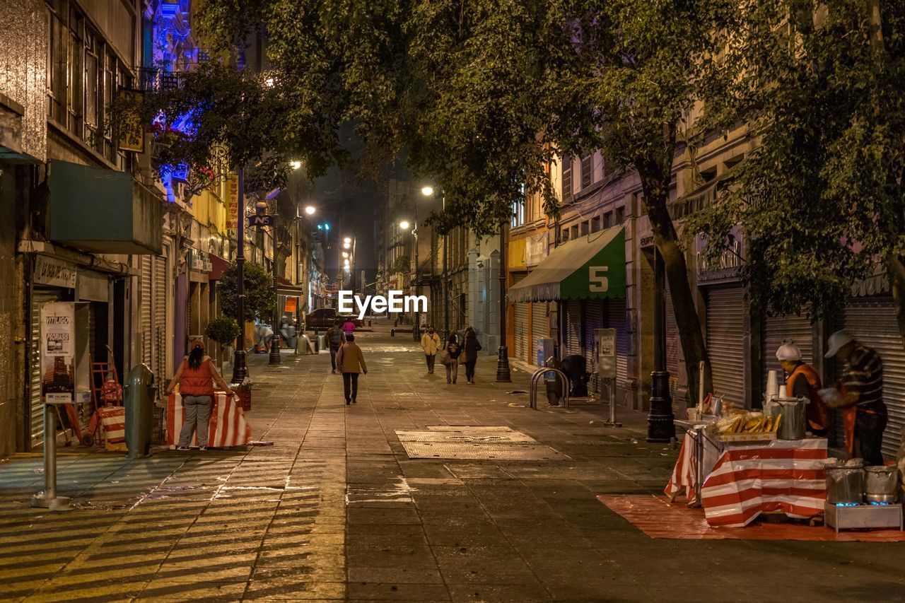 People on street in city at night