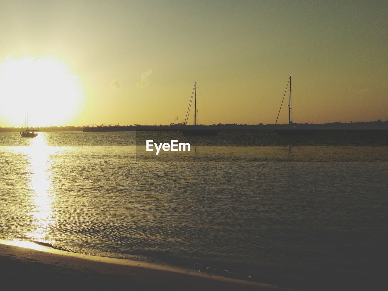 VIEW OF SAILBOAT AT SUNSET