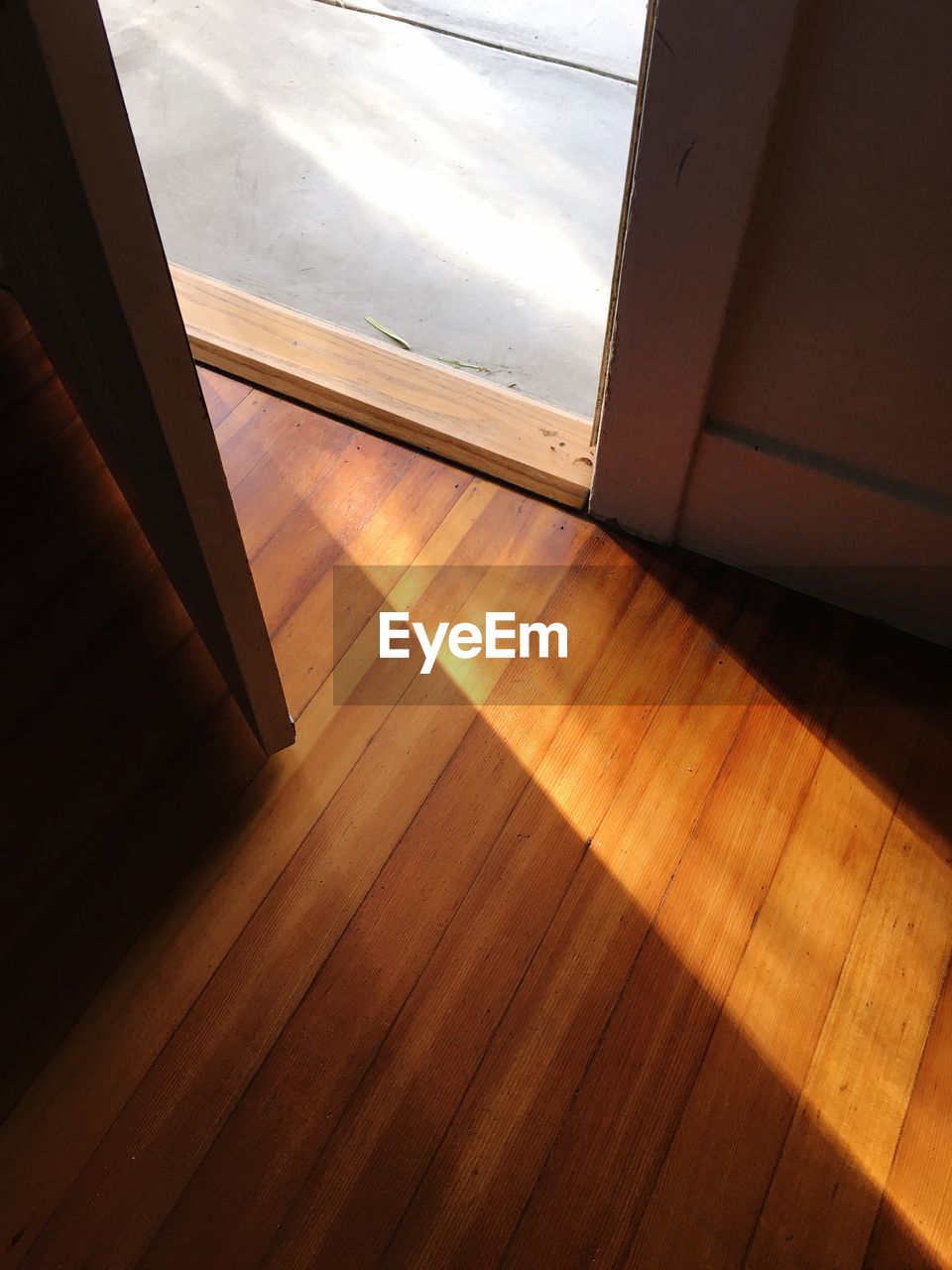 High angle view of sunlight falling on hardwood floor at home