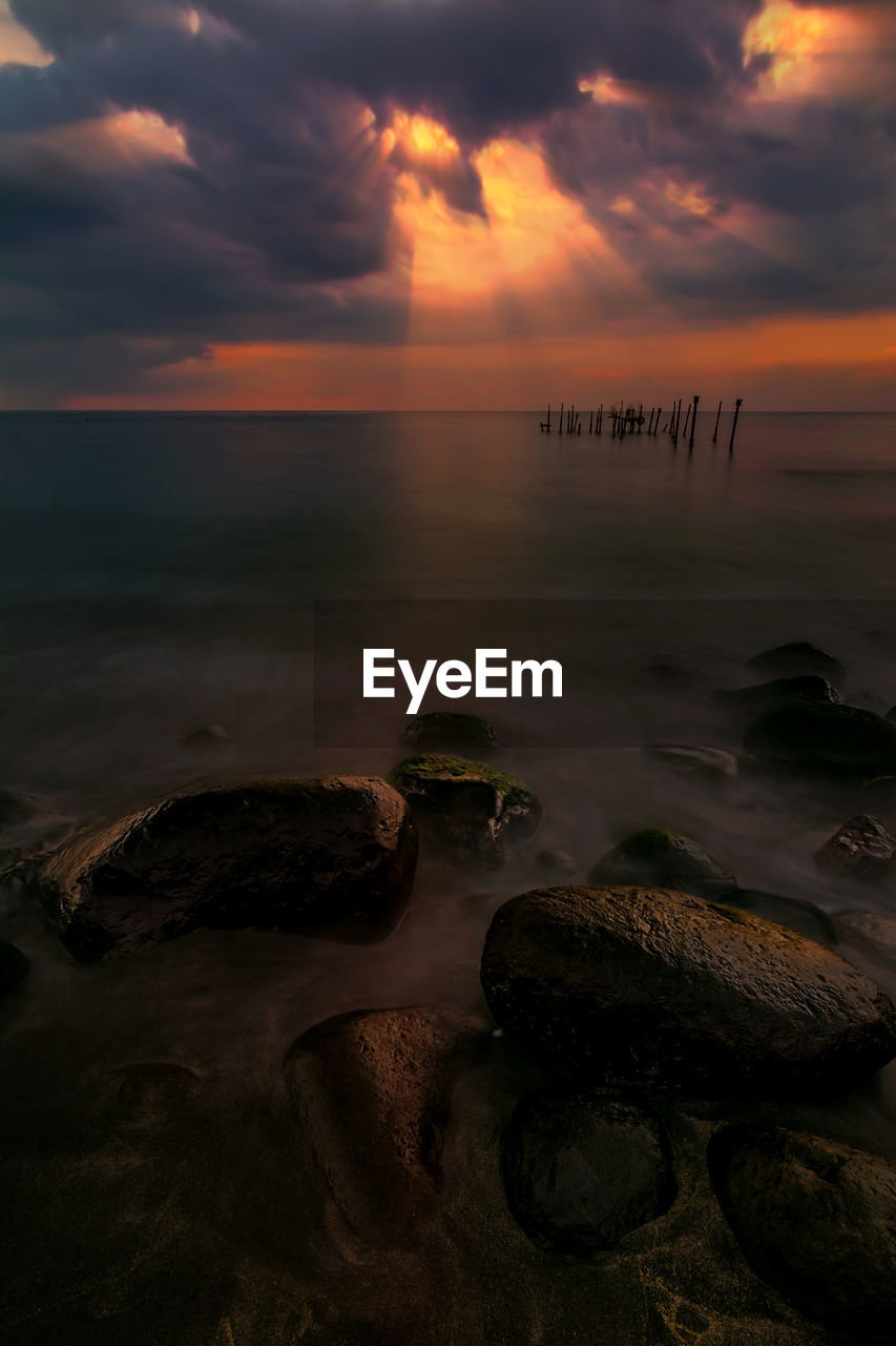 Scenic view of sea against cloudy sky