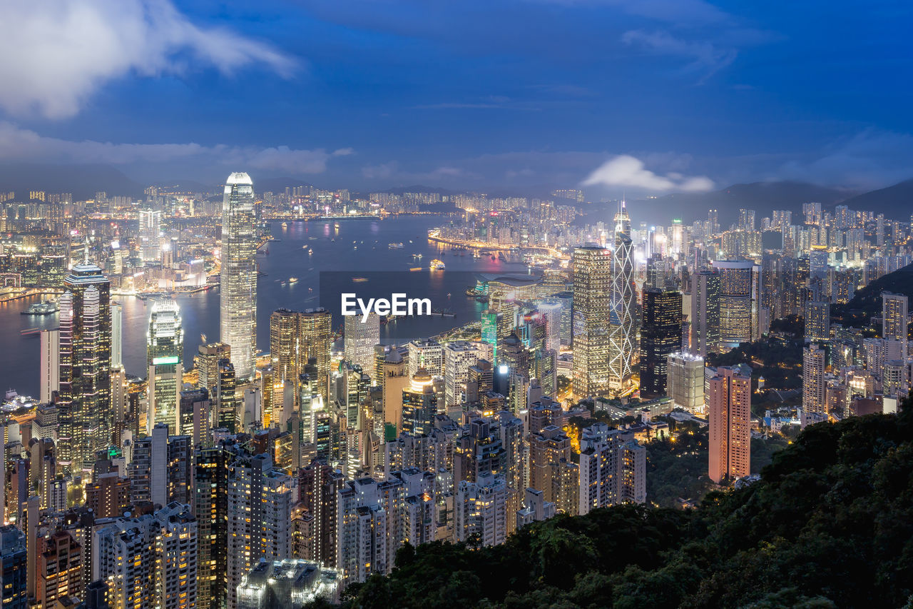 High angle view of illuminated cityscape against sky at night