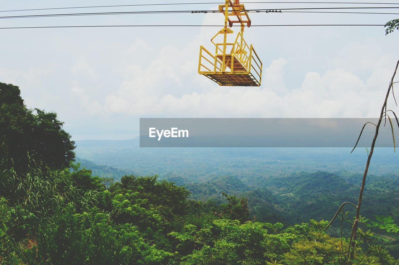 LOW ANGLE VIEW OF A OVERHEAD CABLE CAR AGAINST SKY