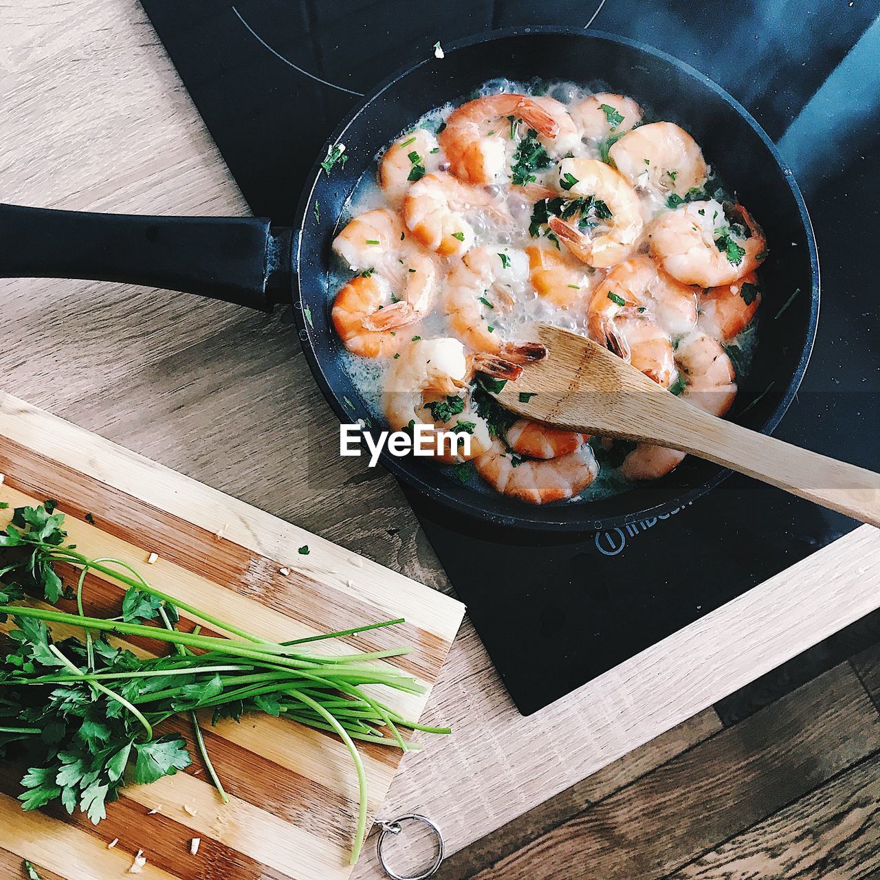 Directly above shot of shrimp in cooking pan on induction