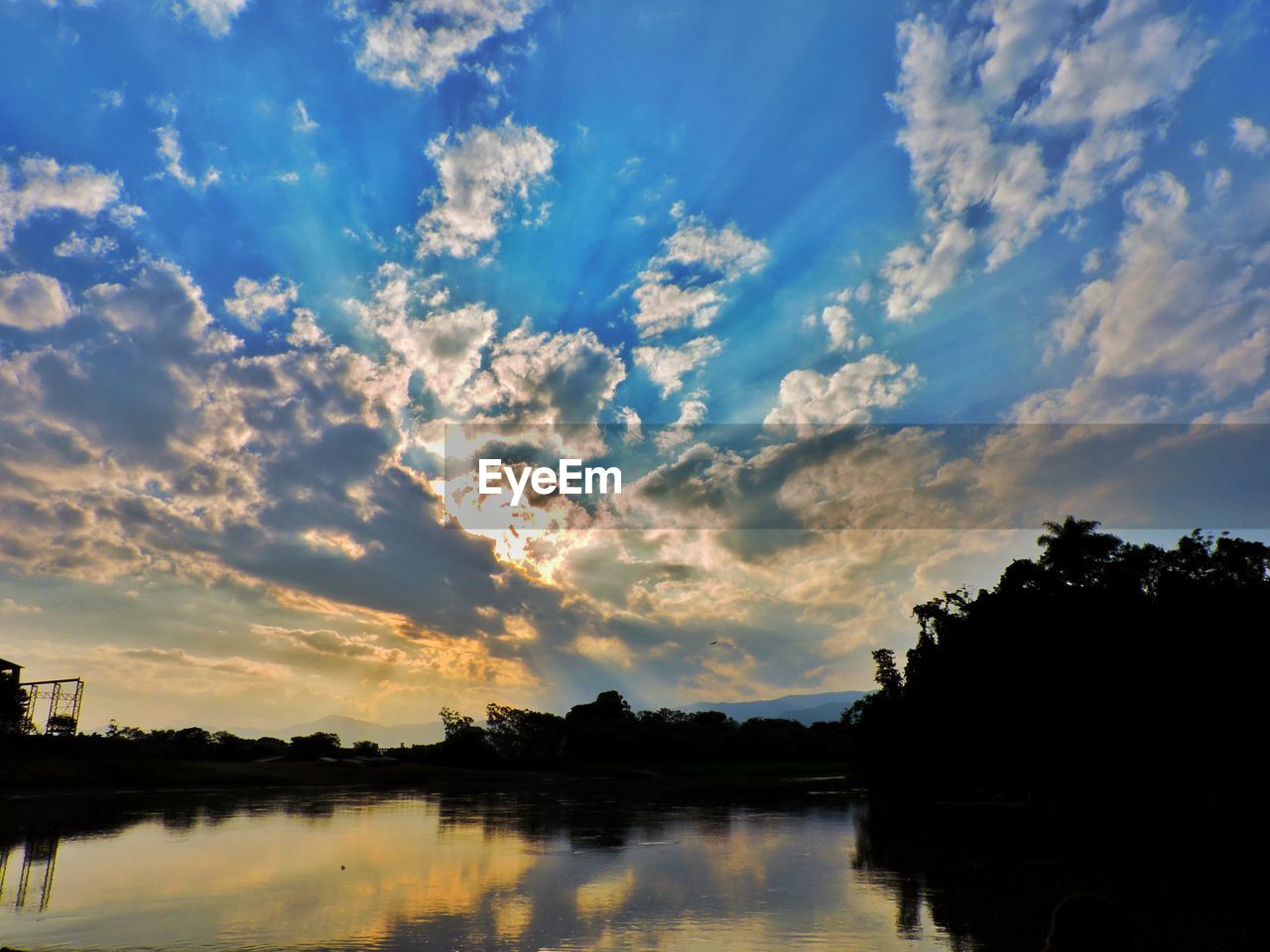 SCENIC VIEW OF LAKE AT SUNSET