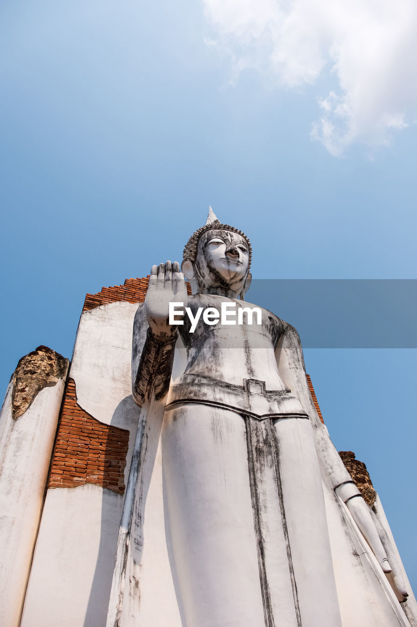 Low angle view of statue against blue sky