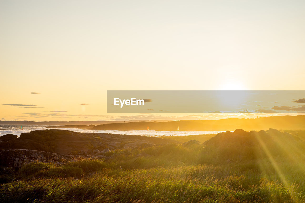 Scenic view of field against sky during sunset