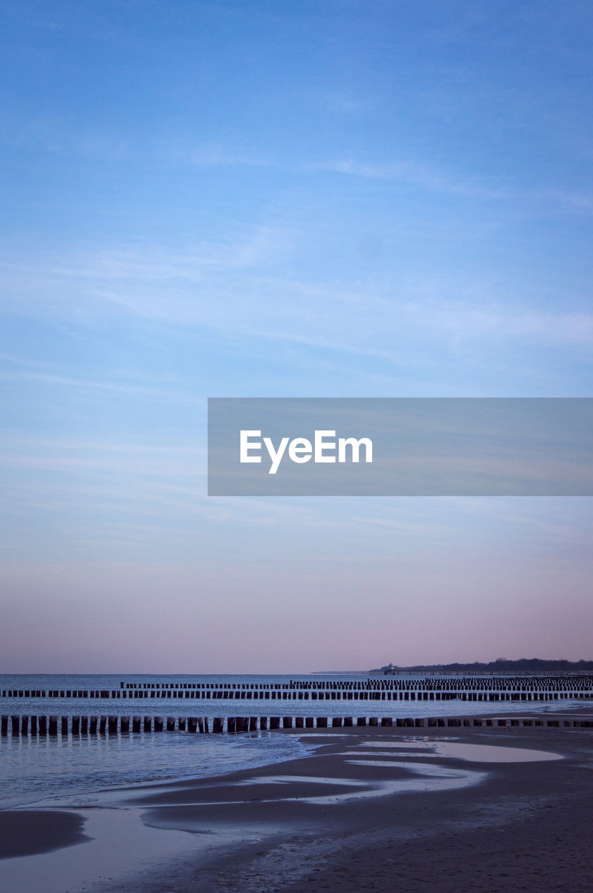 Scenic view of land against sky during sunset