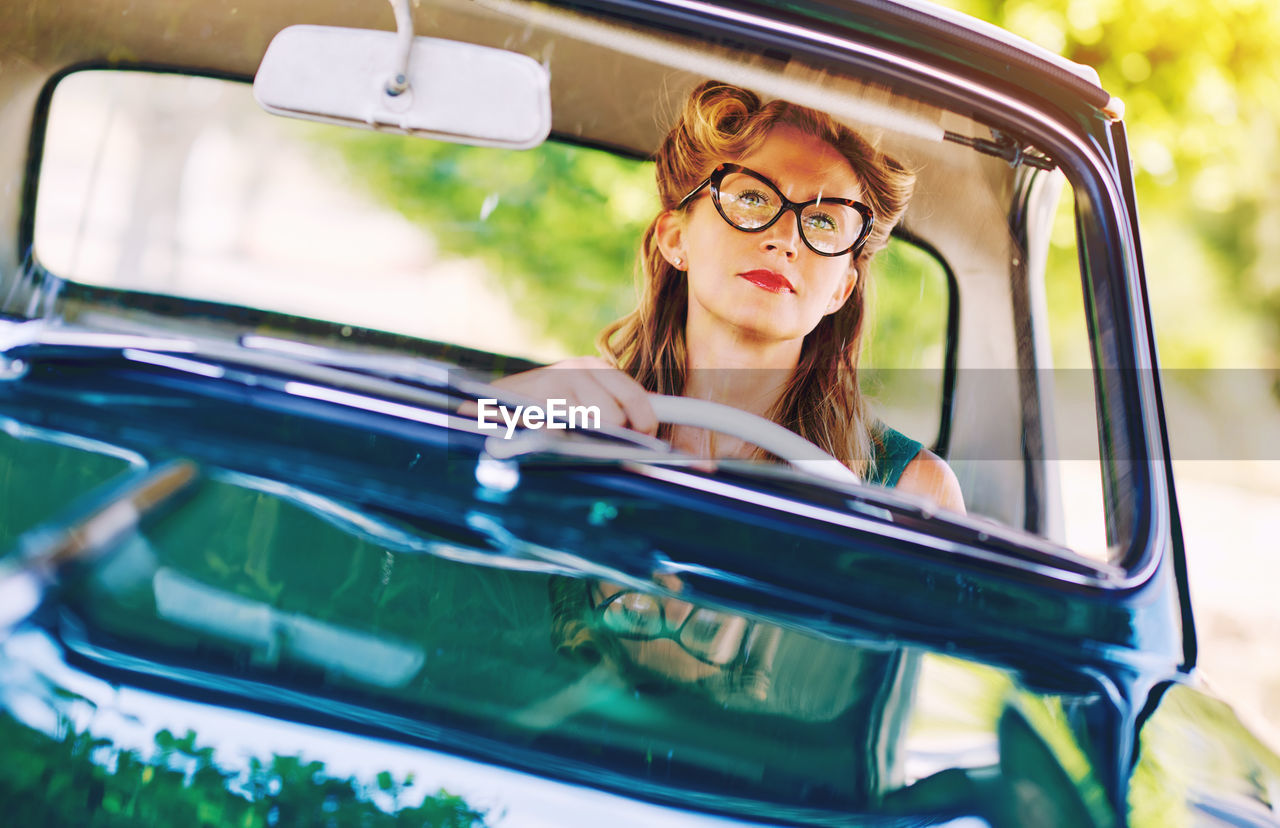 Portrait of smiling young woman in car
