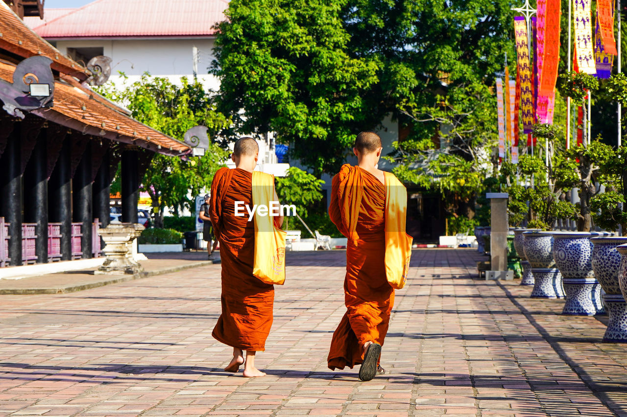 Buddhist monks walking in temple complex in chiang mai thailand