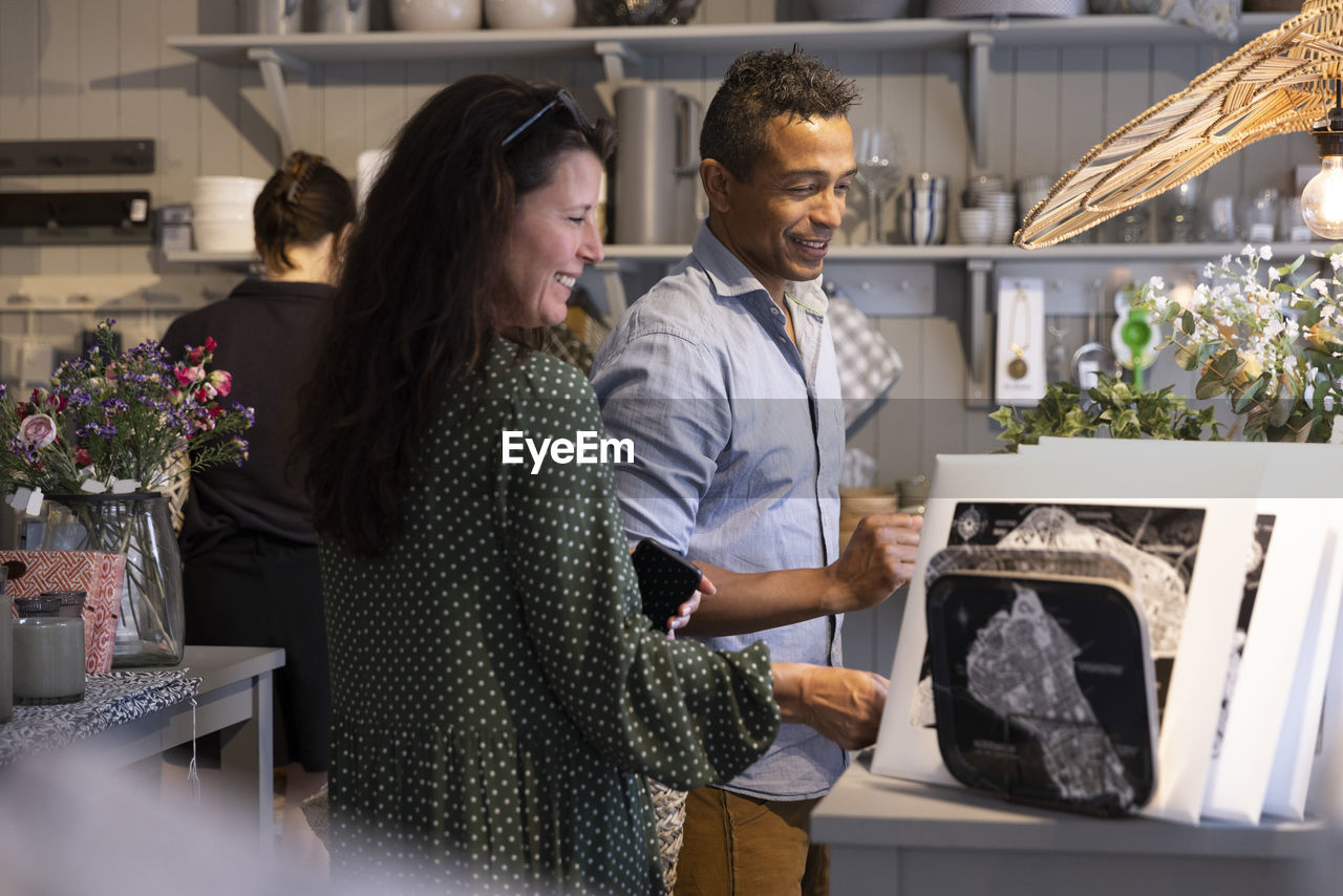 Smiling mature couple shopping together in store