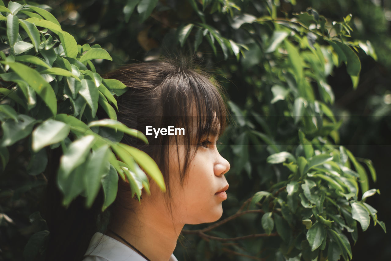 Close-up of teenage girl looking away