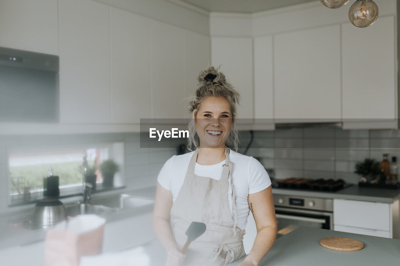 Smiling woman in kitchen