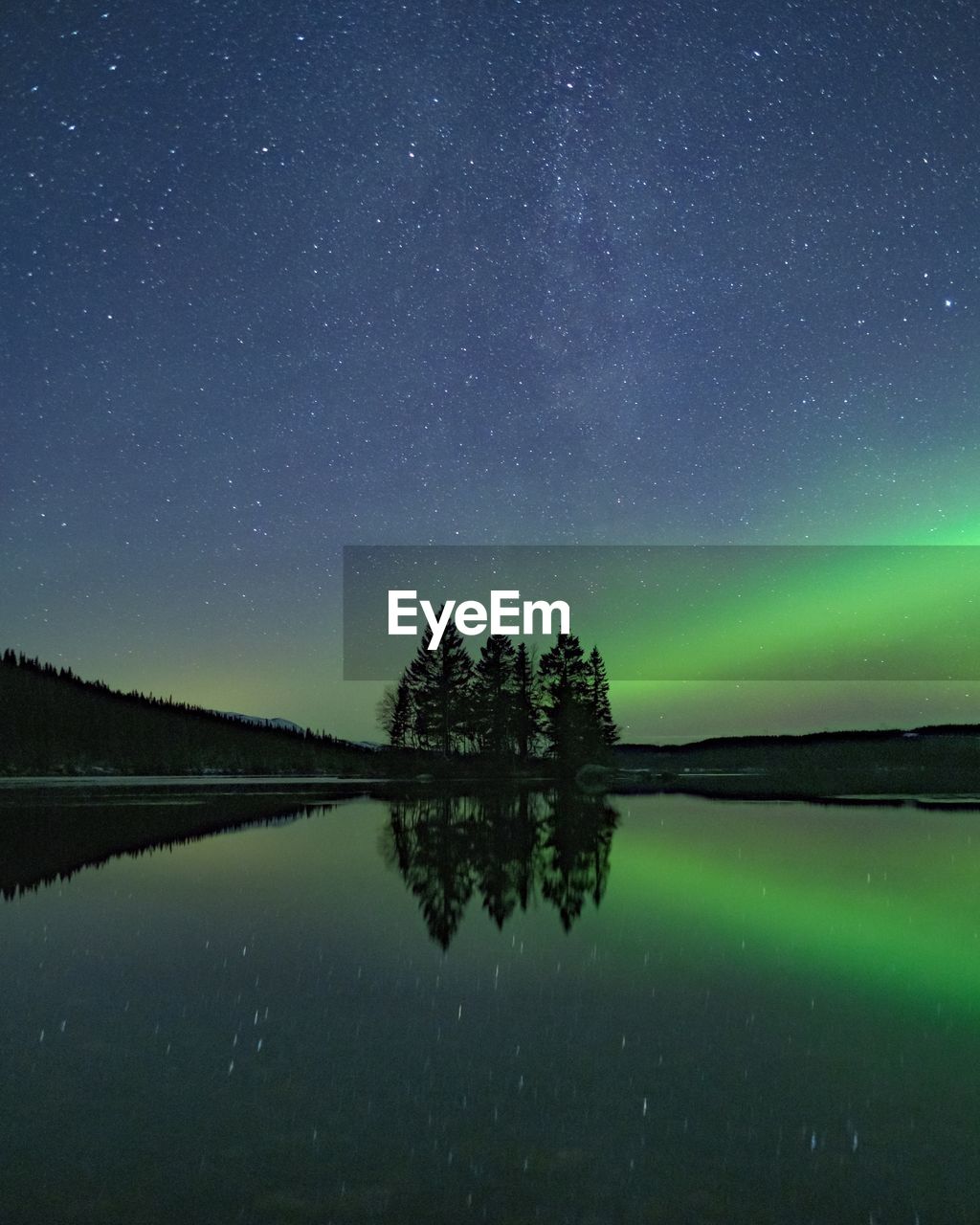 Scenic view of lake against sky at night