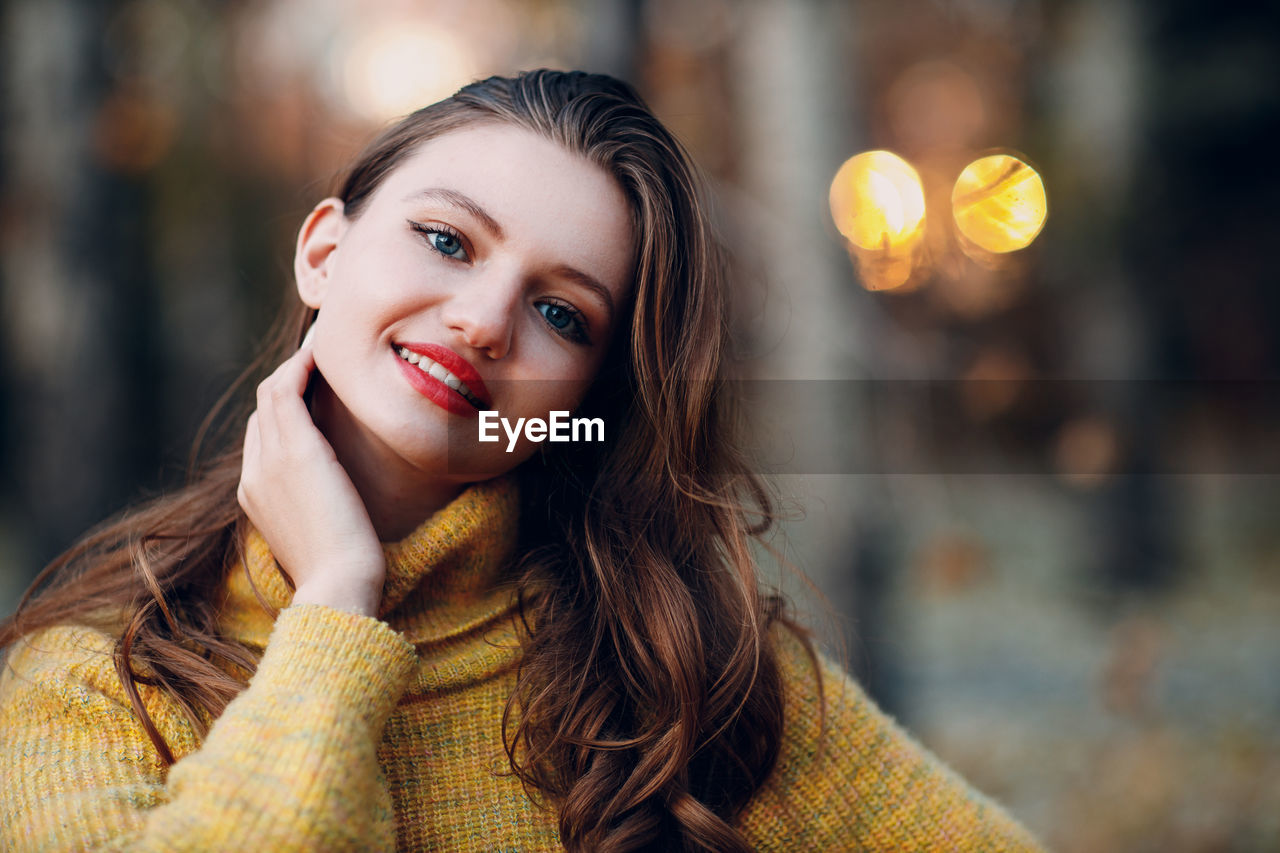 portrait of young woman looking away against sky during sunset