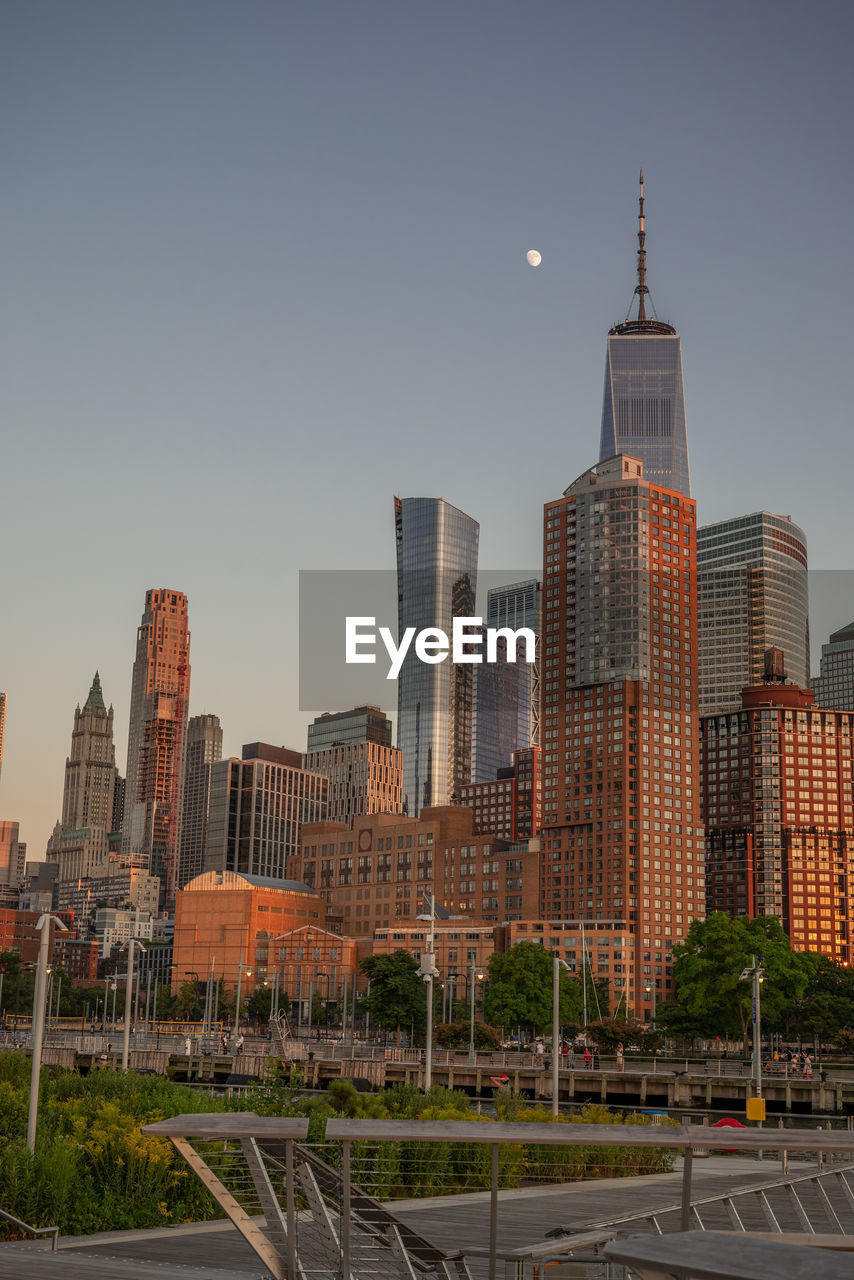 Buildings in city against clear sky