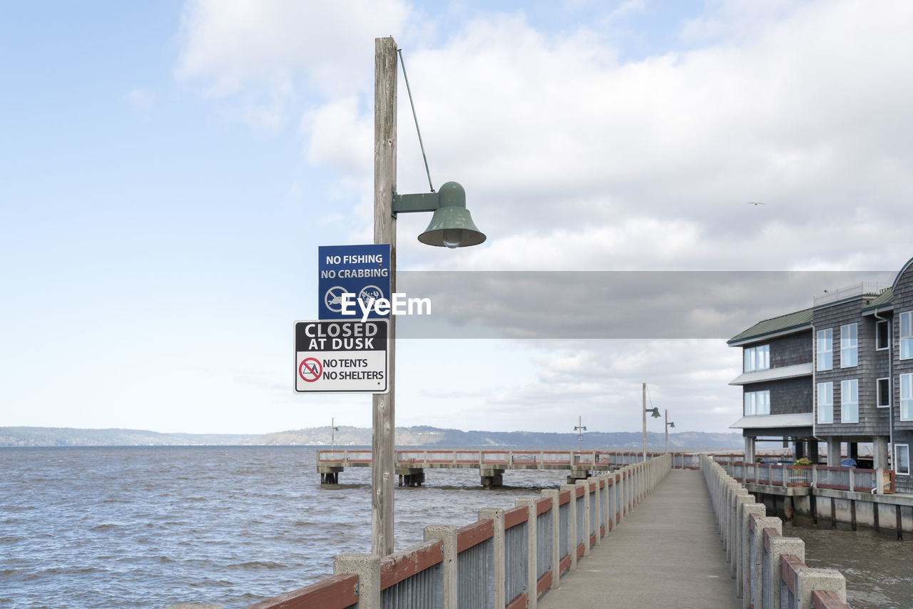 VIEW OF ROAD SIGN BY SEA