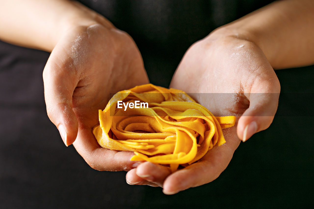 Close-up of hand holding pasta