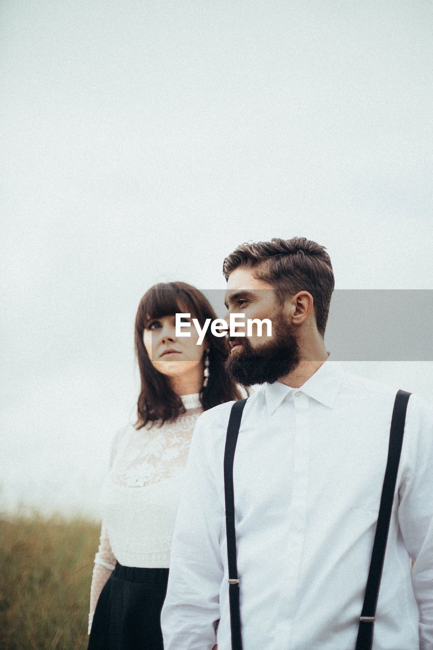 Young couple standing on field