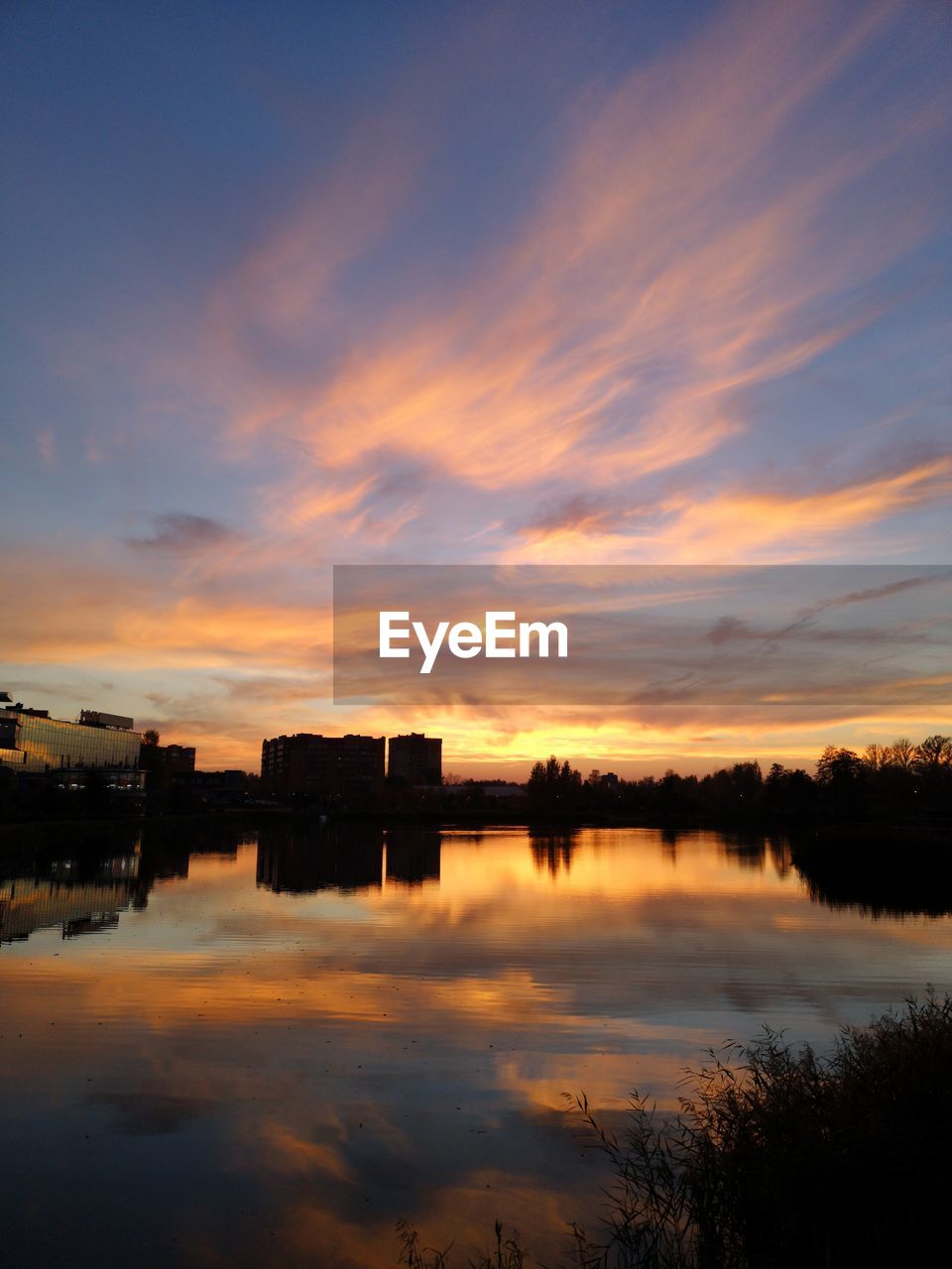 Scenic view of lake against sky during sunset