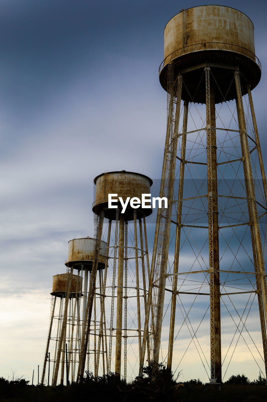 Water towers at sunflower ammunition plant before a storm