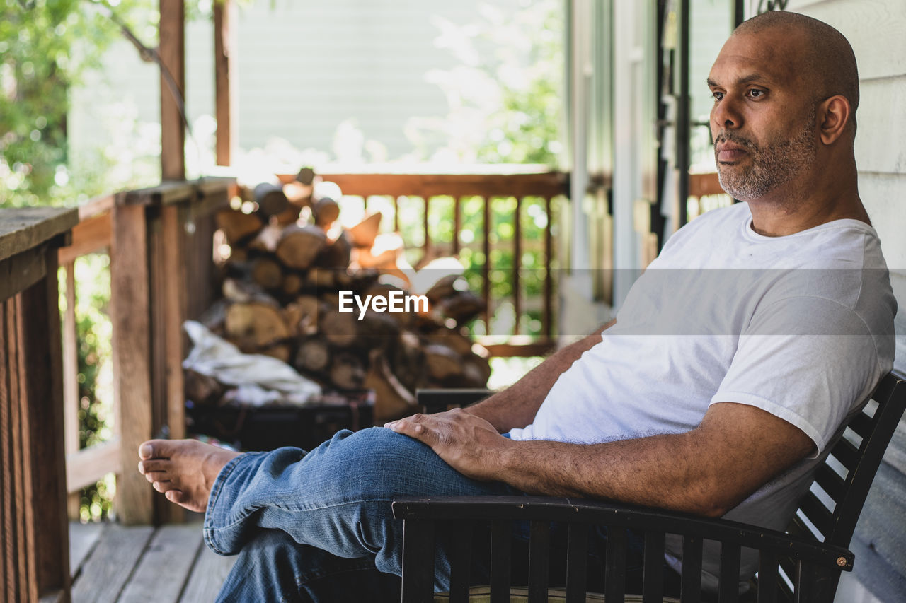 Thoughtful man sitting on chair indoors