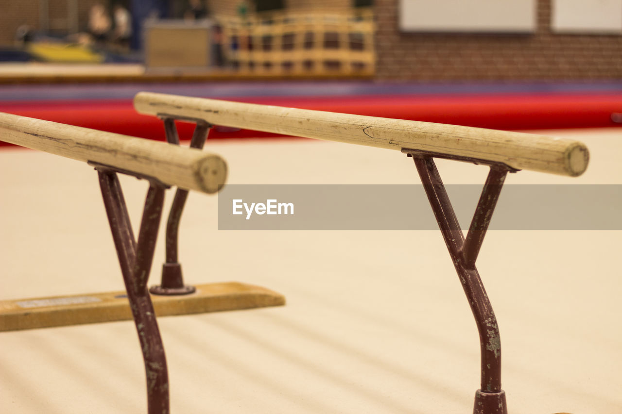 CLOSE-UP OF WOODEN TABLE BY RAILING