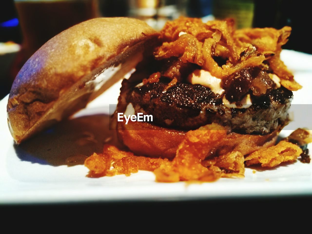 Close-up of double cheese with onion and bacon served in plate