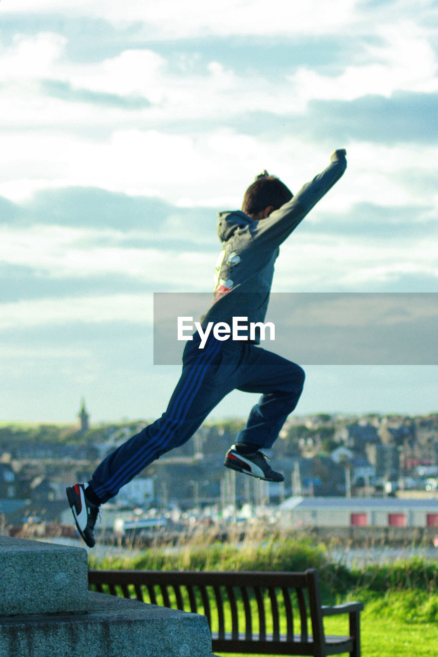 MAN JUMPING FROM RAILING