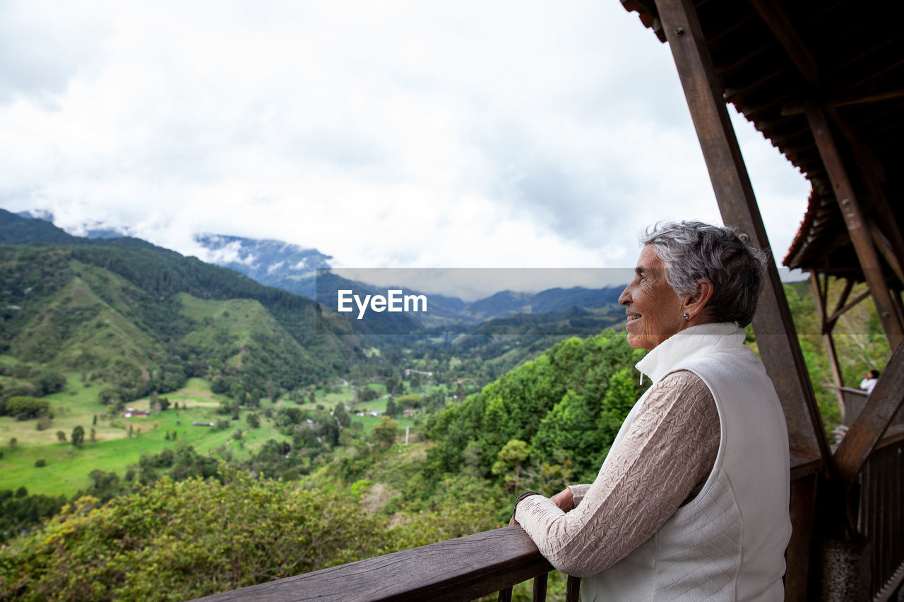Senior woman at the beautiful view point over the cocora valley in salento  in colombia