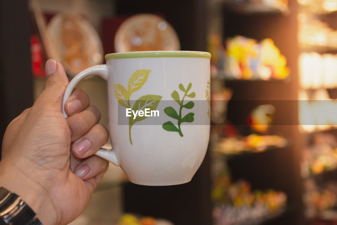 Close-up of woman holding coffee cup